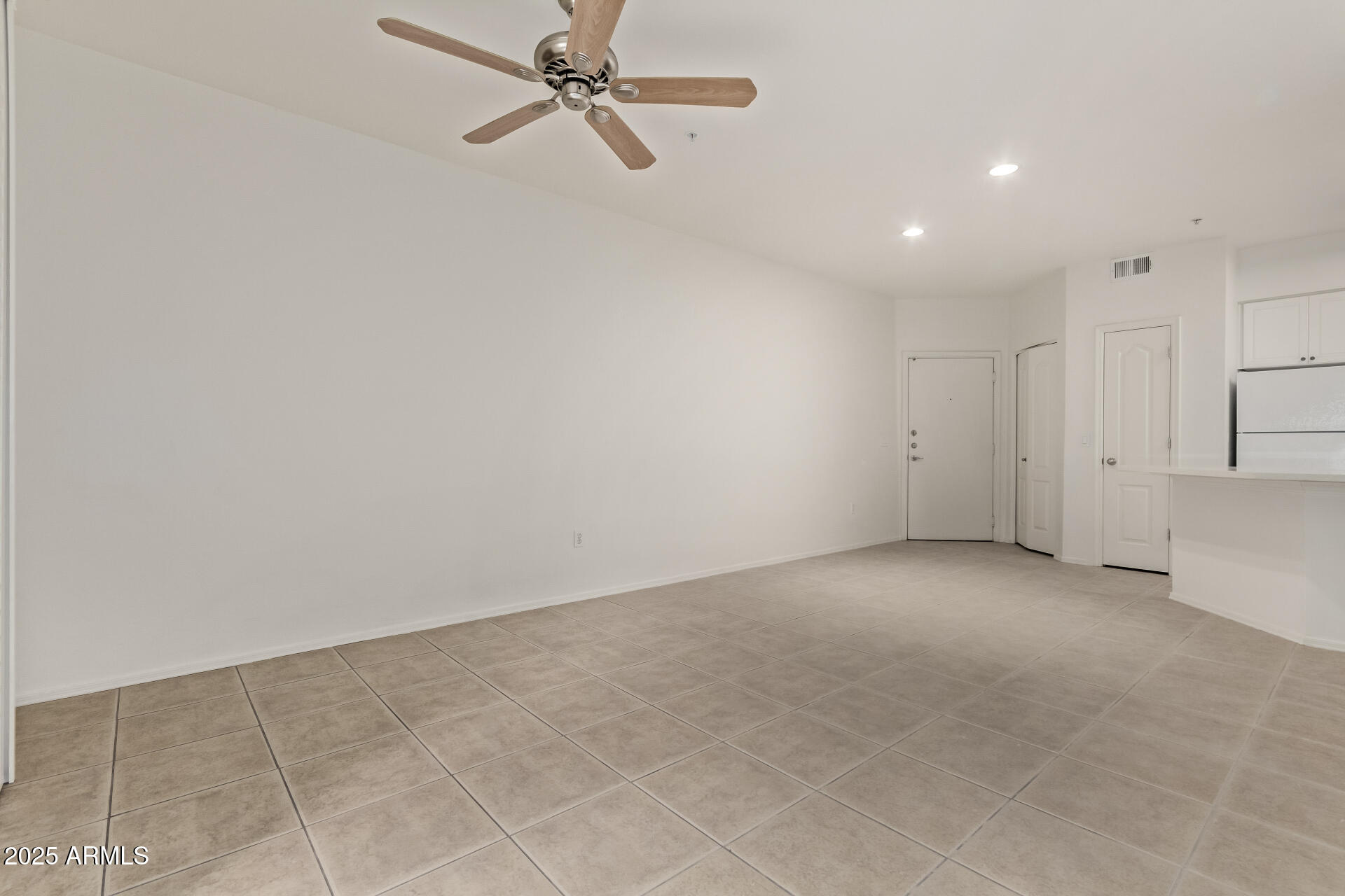 1701 East Colter Street, Unit 191 Phoenix, AZ 85016 - Photo 16 of 32 an empty room with a ceiling fan and carpet