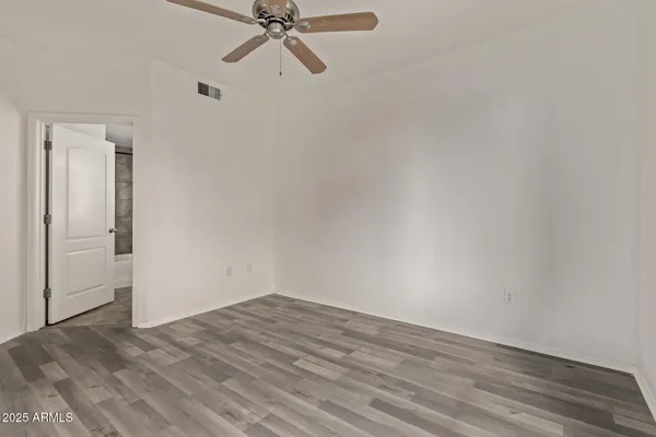 a view of a room with wooden floor
