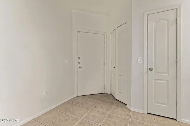 a view of a room with wooden floor and a window