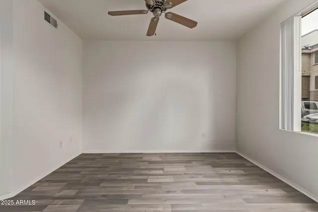 a view of a room with wooden floor
