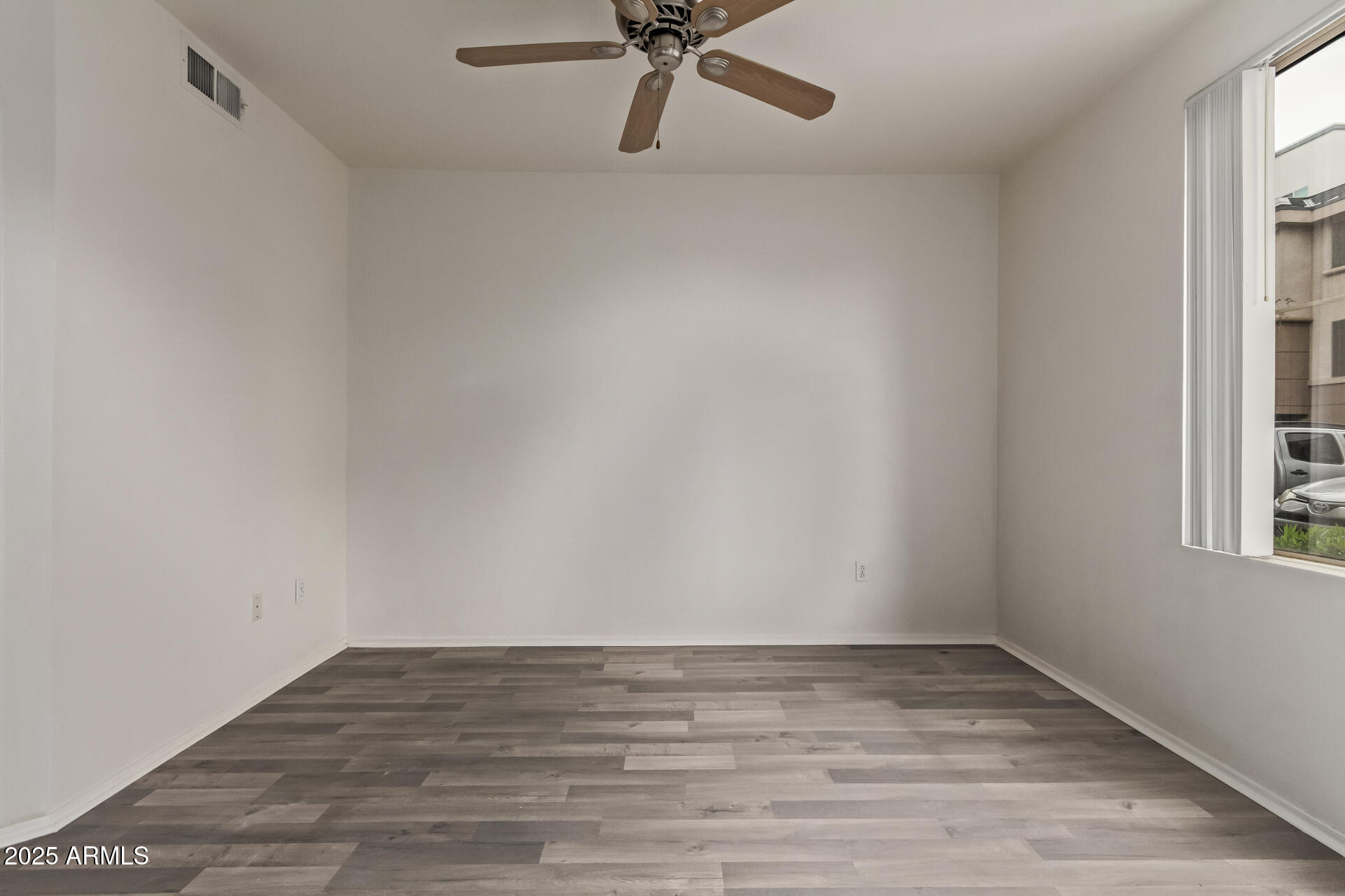 1701 East Colter Street, Unit 191 Phoenix, AZ 85016 - Photo 19 of 33 a view of a room with wooden floor and a window