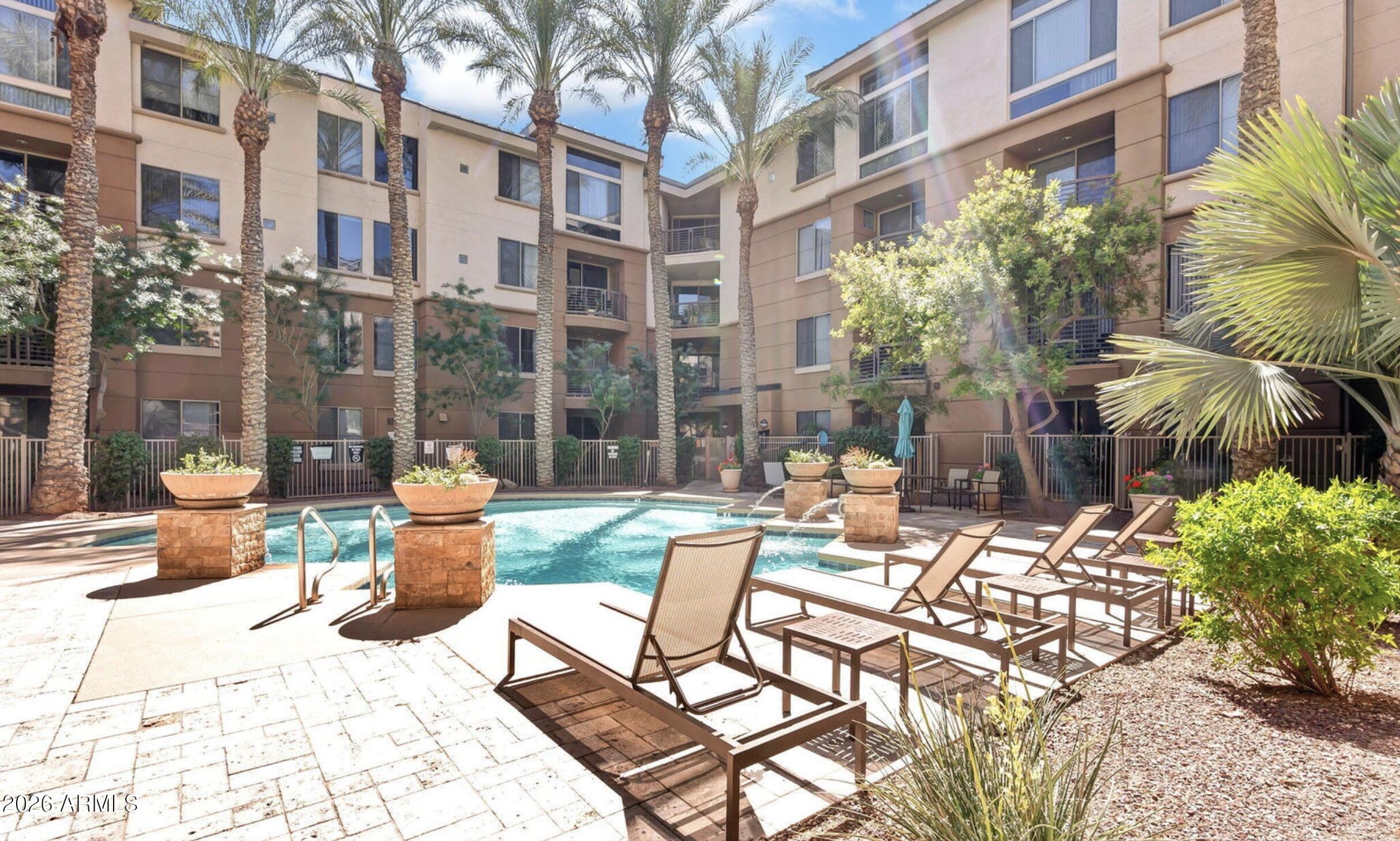 1701 East Colter Street, Unit 191 Phoenix, AZ 85016 - Photo 21 of 32 a view of a patio with a table and chairs and potted plants