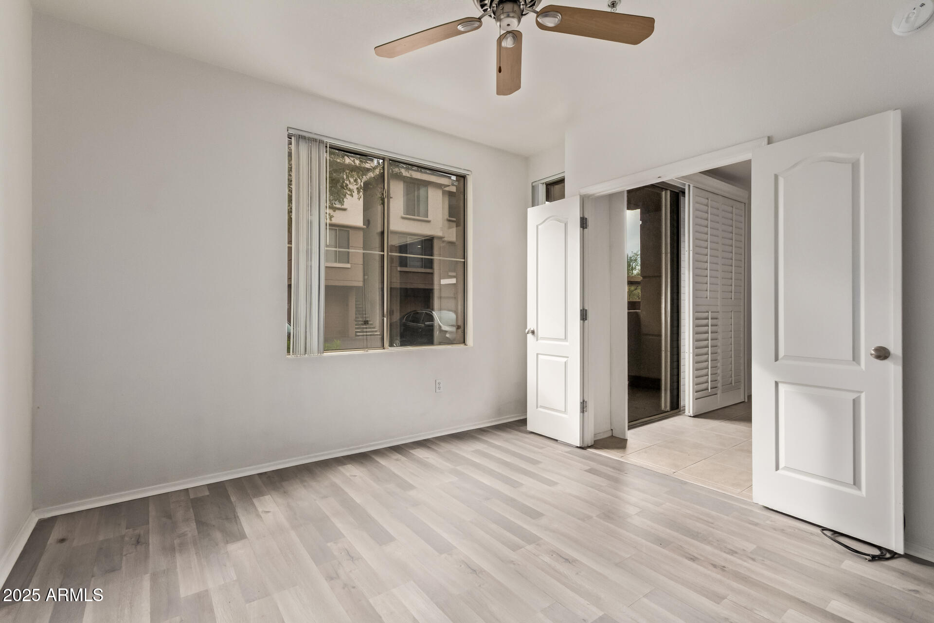 1701 East Colter Street, Unit 191 Phoenix, AZ 85016 - Photo 21 of 33 a view of an empty room with a window and wooden floor