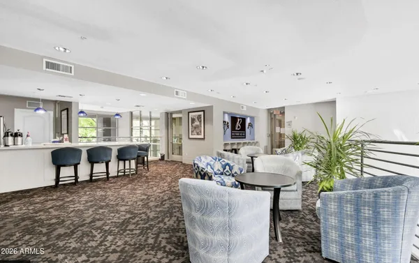 a living room with furniture and a potted plant