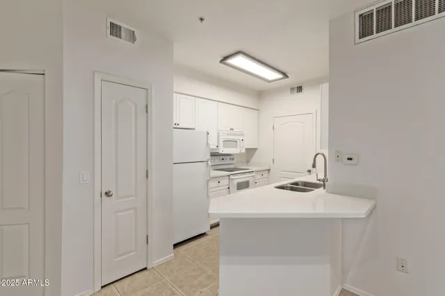 a kitchen with stainless steel appliances a sink stove and refrigerator