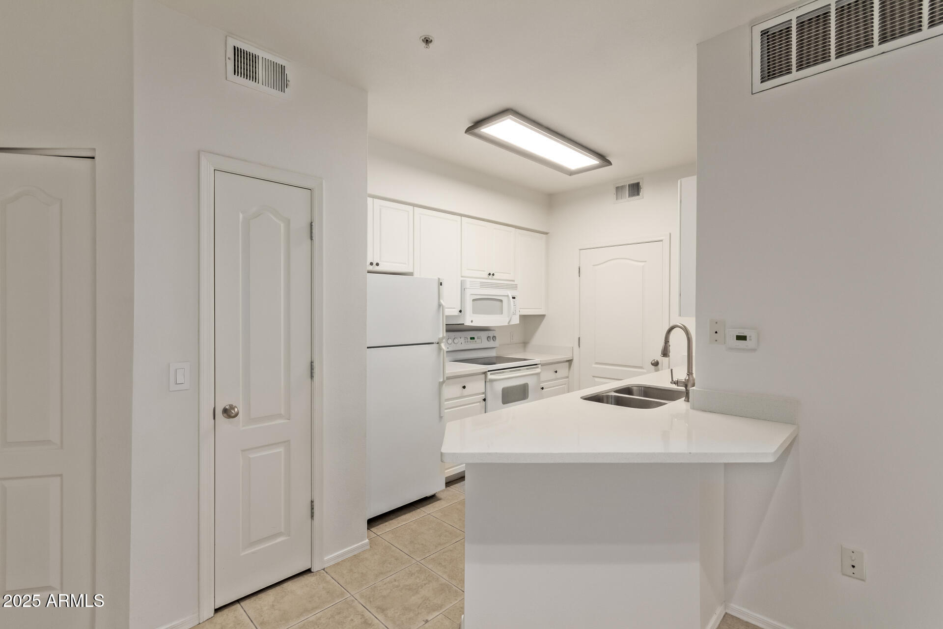 1701 East Colter Street, Unit 191 Phoenix, AZ 85016 - Photo 6 of 33 a kitchen with stainless steel appliances a sink stove and refrigerator