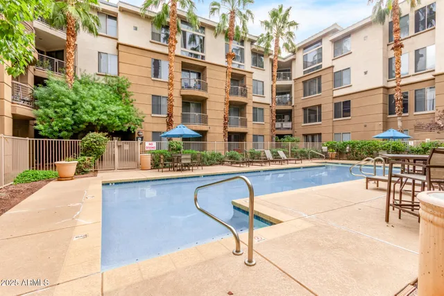 a swimming pool with outdoor seating and yard