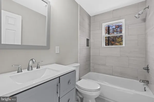 a bathroom with a sink a toilet and a bathtub