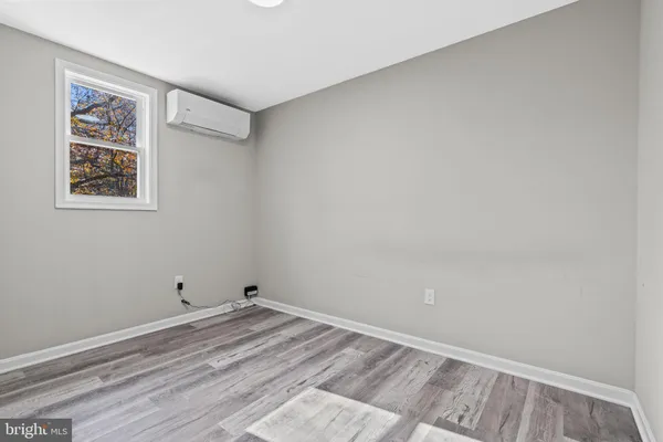 a view of a room with wooden floor and closet