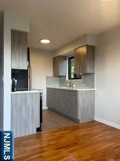 a view of kitchen with cabinets and wooden floor