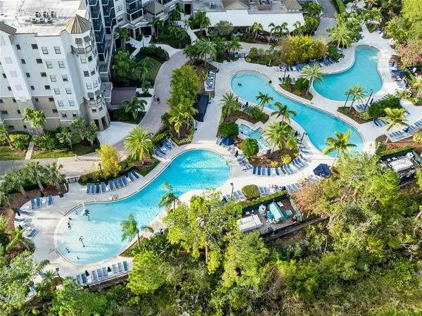 an aerial view of a house with a yard and lake view