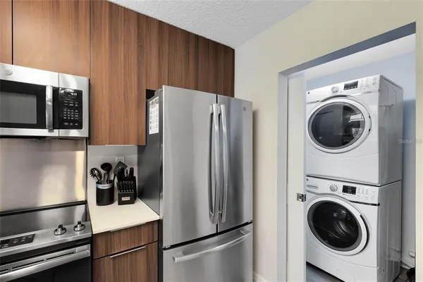 a kitchen with stainless steel appliances granite countertop a refrigerator and a stove top oven