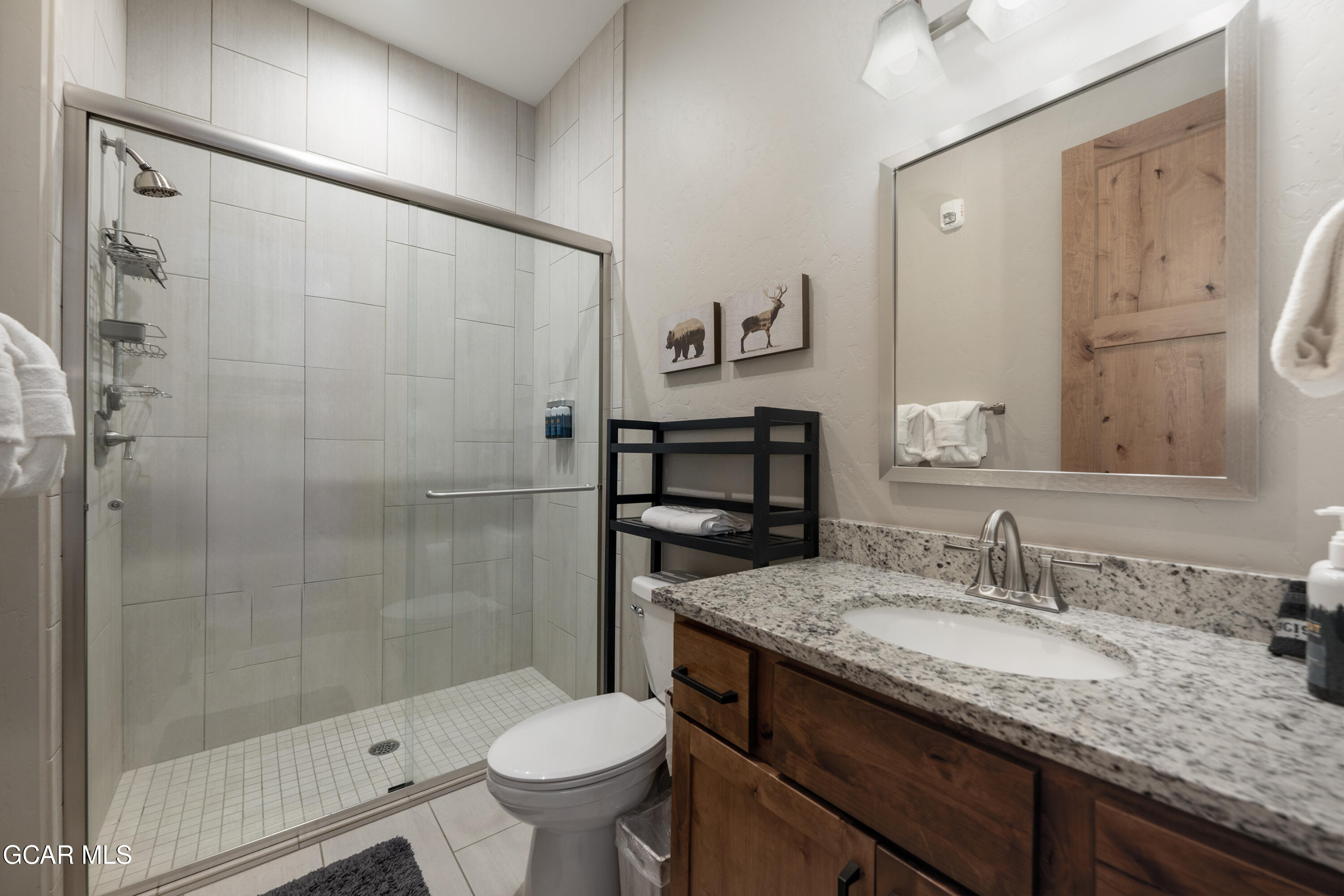 40 Springview Lane Fraser, CO 80442 - Photo 9 of 36 a bathroom with a granite countertop sink toilet and shower