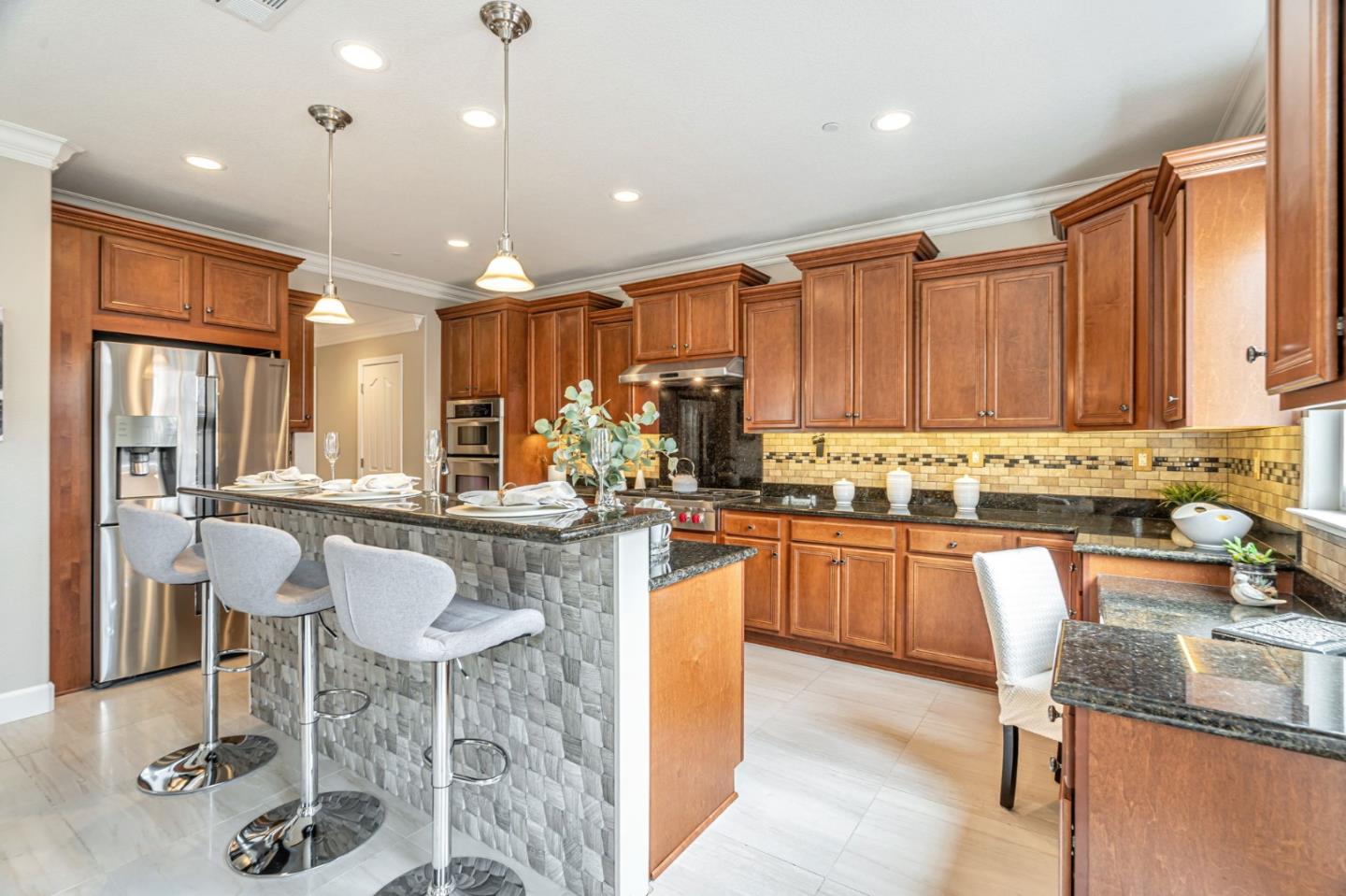6525 Gravina Loop San Jose, CA 95138 - Photo 19 of 63 a kitchen with granite countertop a table chairs stove top oven and sink
