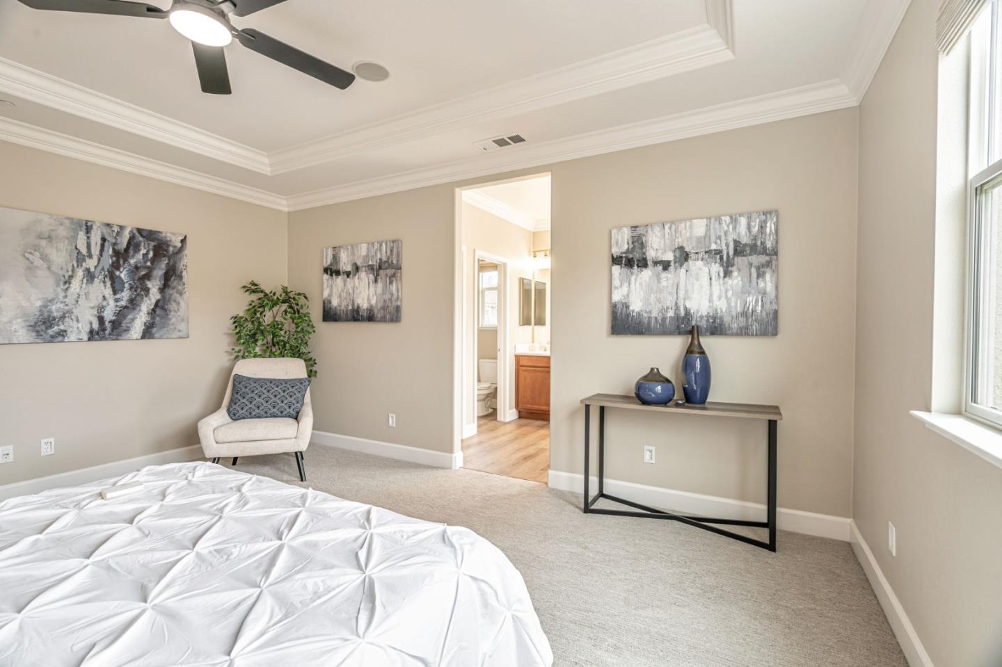 6525 Gravina Loop San Jose, CA 95138 - Photo 27 of 63 a spacious bedroom with a bed and a chair