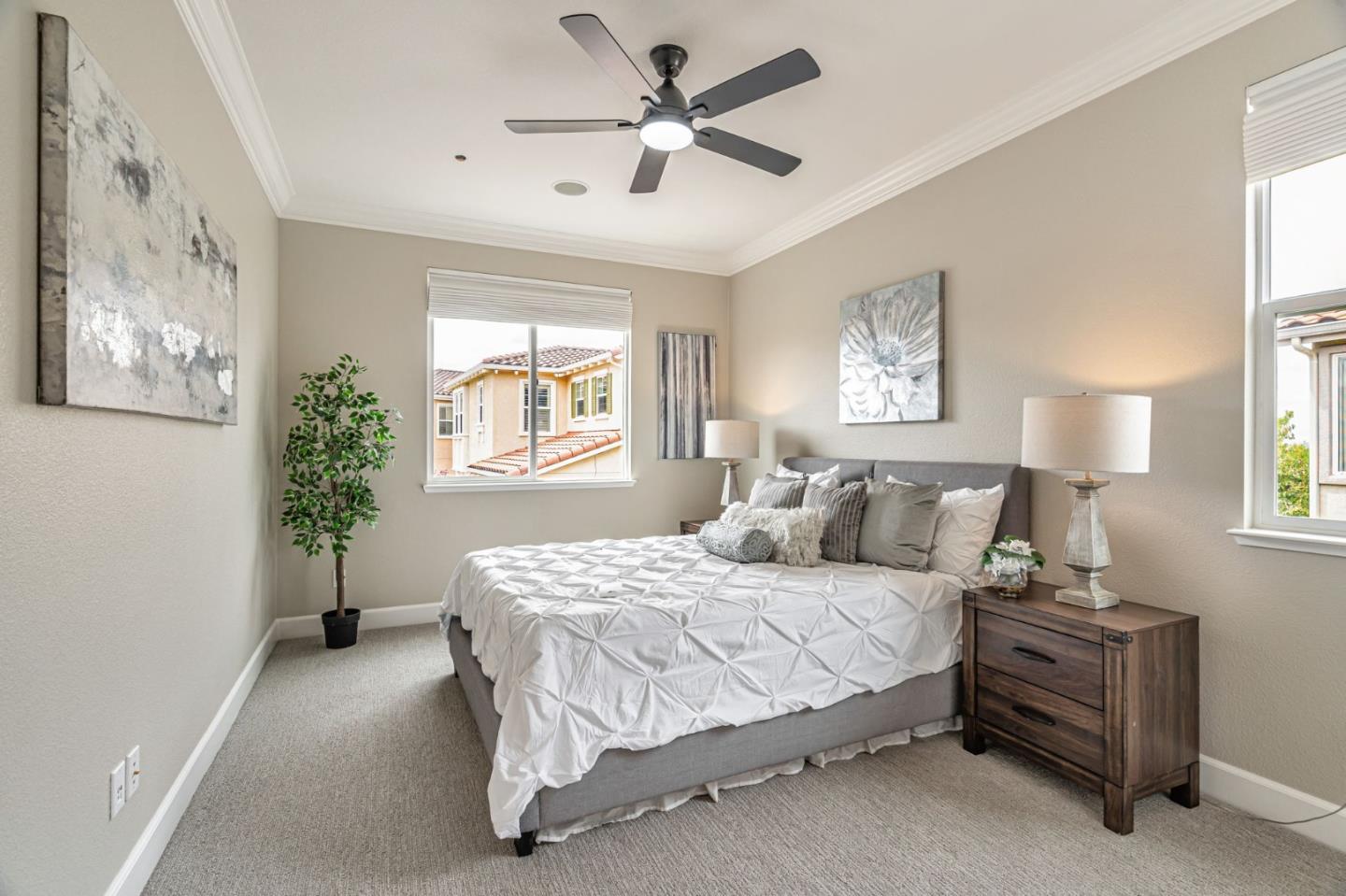 6525 Gravina Loop San Jose, CA 95138 - Photo 29 of 63 a bedroom with a bed and a chandelier