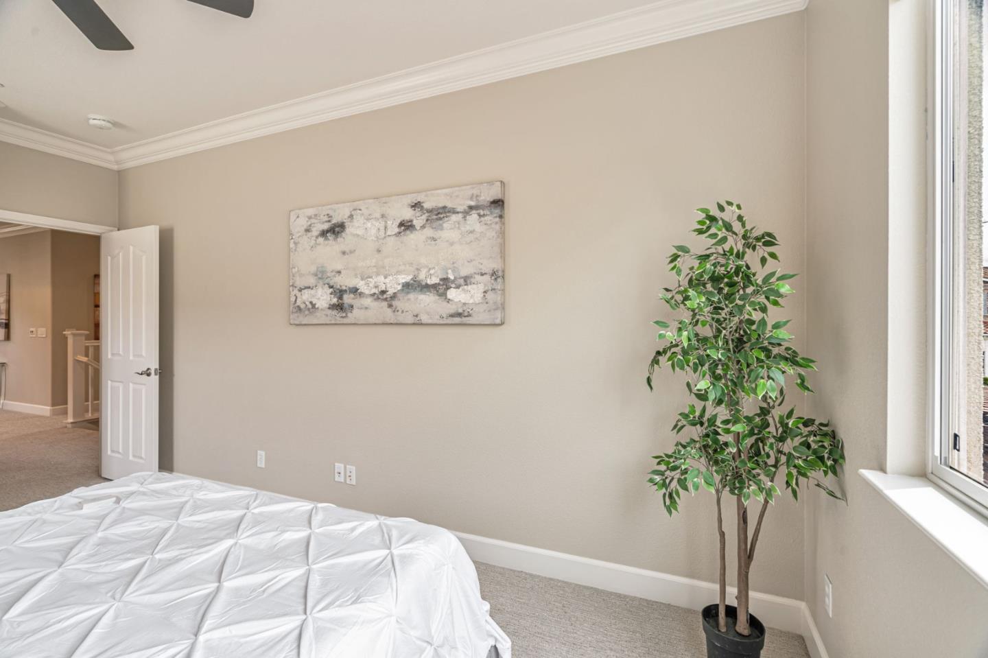 6525 Gravina Loop San Jose, CA 95138 - Photo 30 of 63 a bedroom with a large bed and a potted plant