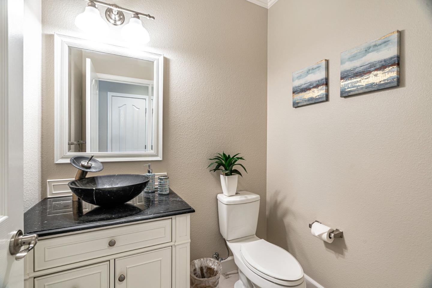 6525 Gravina Loop San Jose, CA 95138 - Photo 37 of 63 a bathroom with a granite countertop toilet sink and mirror