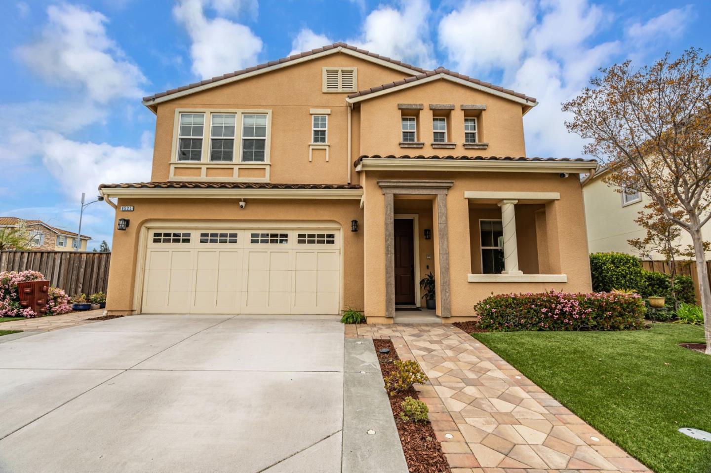 6525 Gravina Loop San Jose, CA 95138 - Photo 6 of 63 a view of a white house with a small yard and large trees