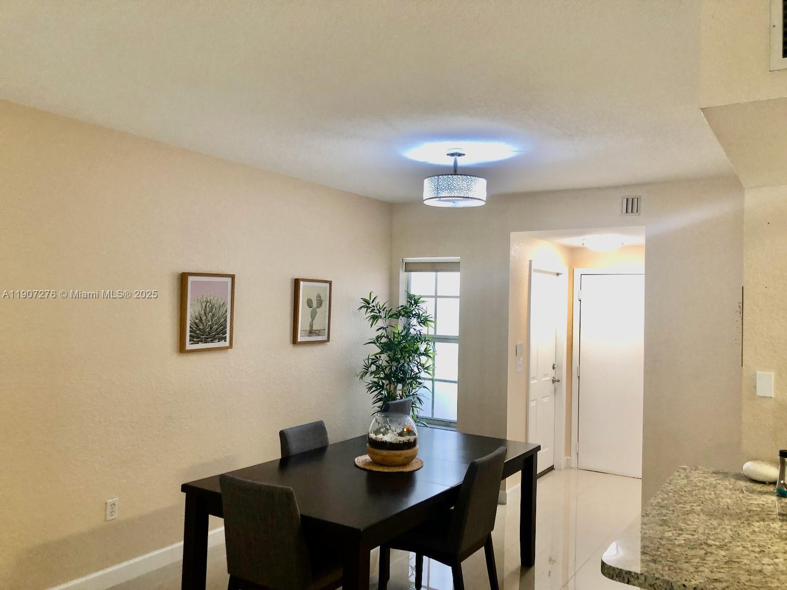 2532 Centergate Drive, Unit 102 Miramar, FL 33025 - Photo 11 of 58 a view of a dining room with furniture and wooden floor