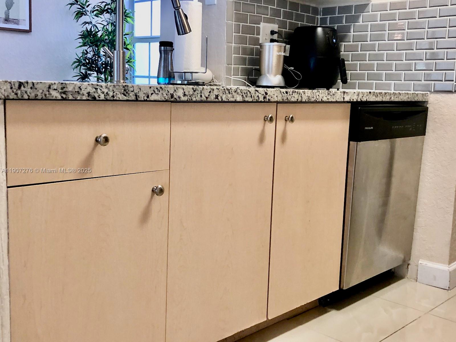 2532 Centergate Drive, Unit 102 Miramar, FL 33025 - Photo 14 of 58 a bathroom with a granite countertop sink and a mirror
