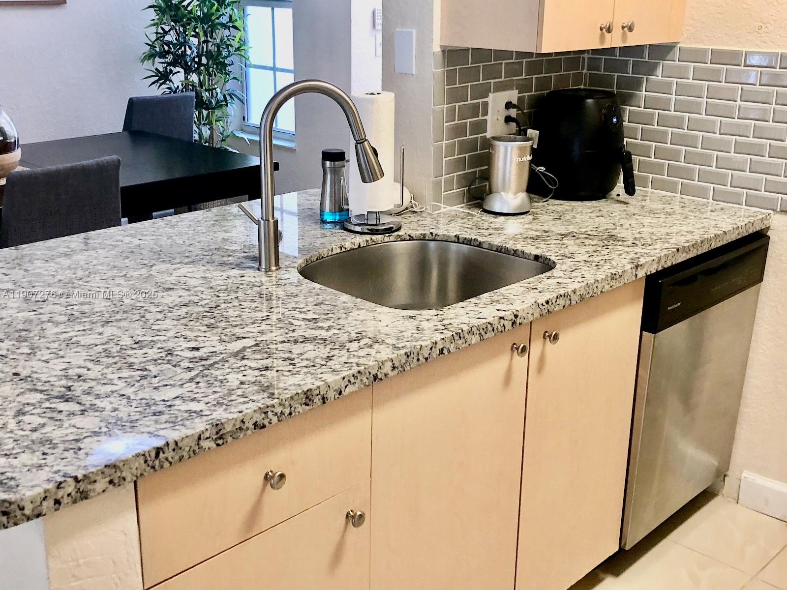 2532 Centergate Drive, Unit 102 Miramar, FL 33025 - Photo 15 of 58 a kitchen with a sink and a refrigerator