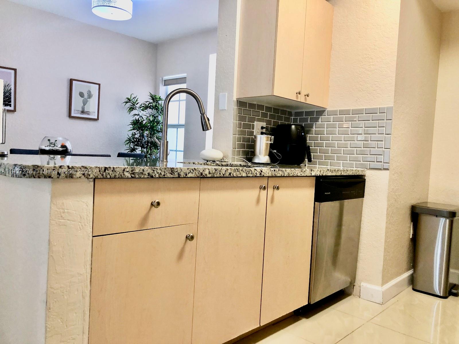 2532 Centergate Drive, Unit 102 Miramar, FL 33025 - Photo 16 of 58 a close view of dining table chair and a refrigerator