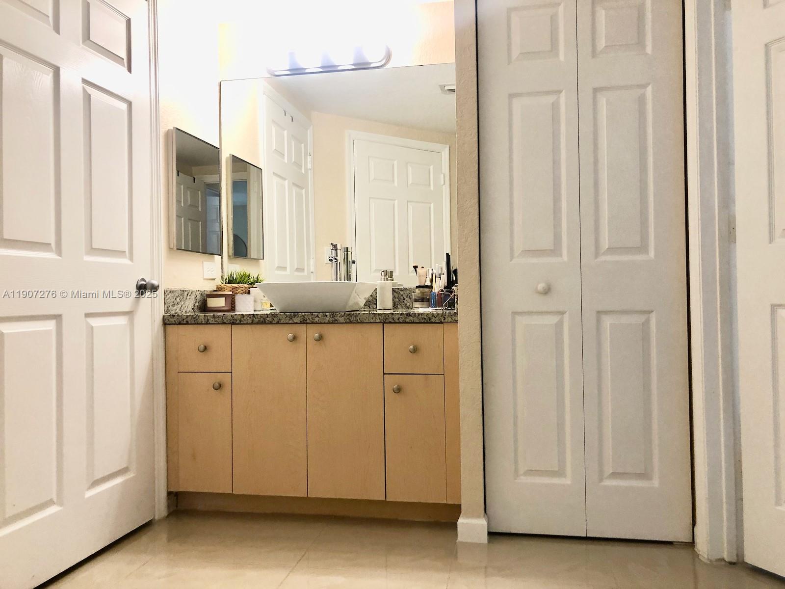 2532 Centergate Drive, Unit 102 Miramar, FL 33025 - Photo 20 of 58 a bathroom with a sink and a mirror