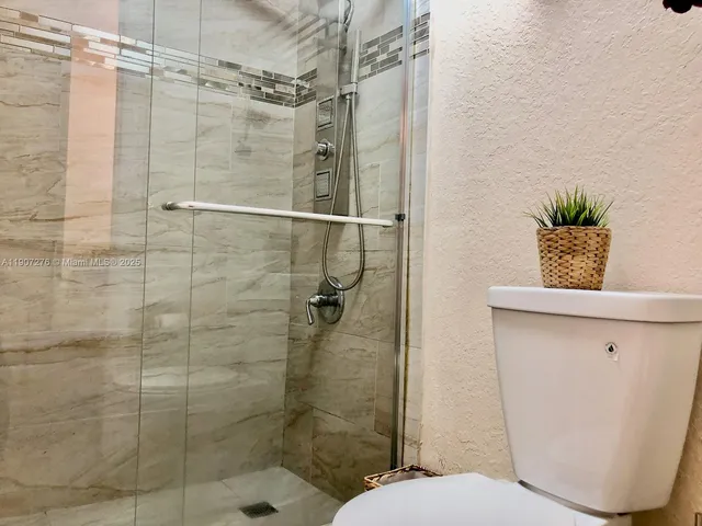 a white toilet sitting next to a bathroom sink