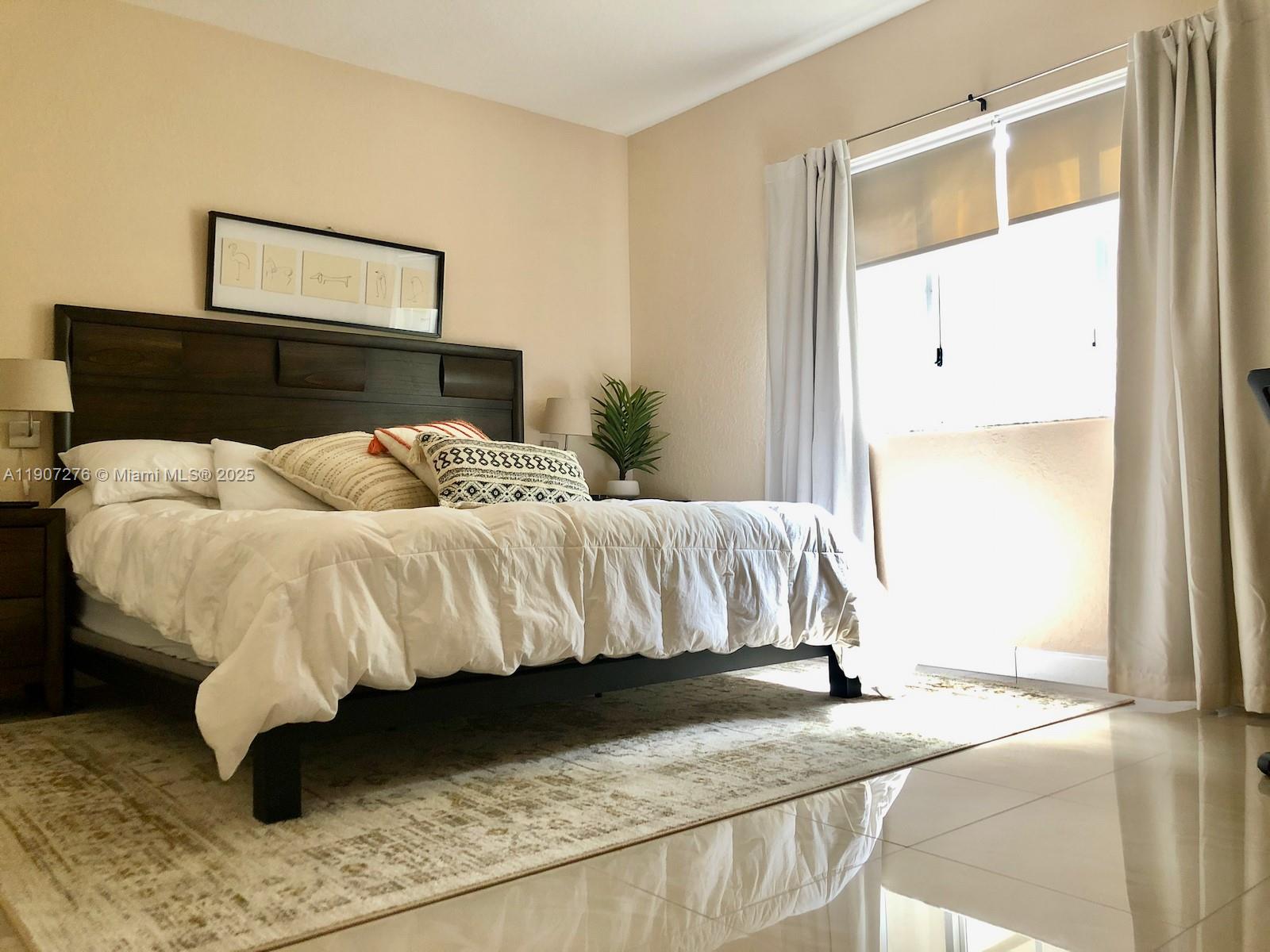 2532 Centergate Drive, Unit 102 Miramar, FL 33025 - Photo 24 of 58 a bedroom with a bed and a window