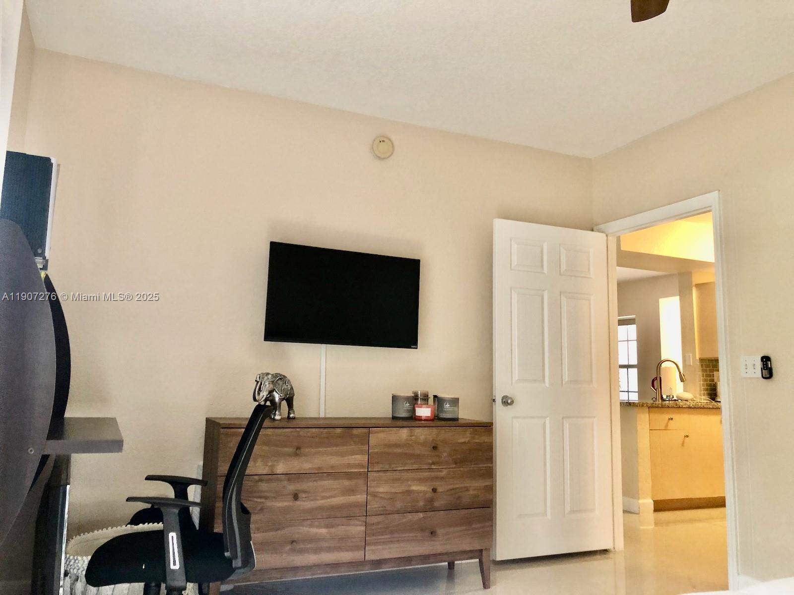 2532 Centergate Drive, Unit 102 Miramar, FL 33025 - Photo 26 of 58 a living room with furniture and a flat screen tv