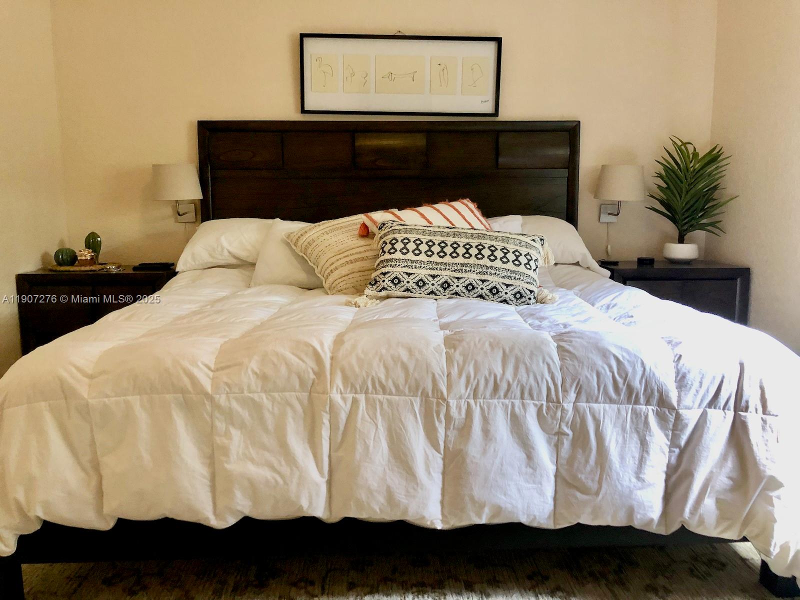 2532 Centergate Drive, Unit 102 Miramar, FL 33025 - Photo 27 of 58 a large white bed in a small room