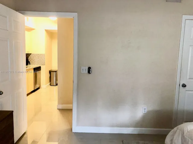 a large bed sitting in a bedroom next to a window