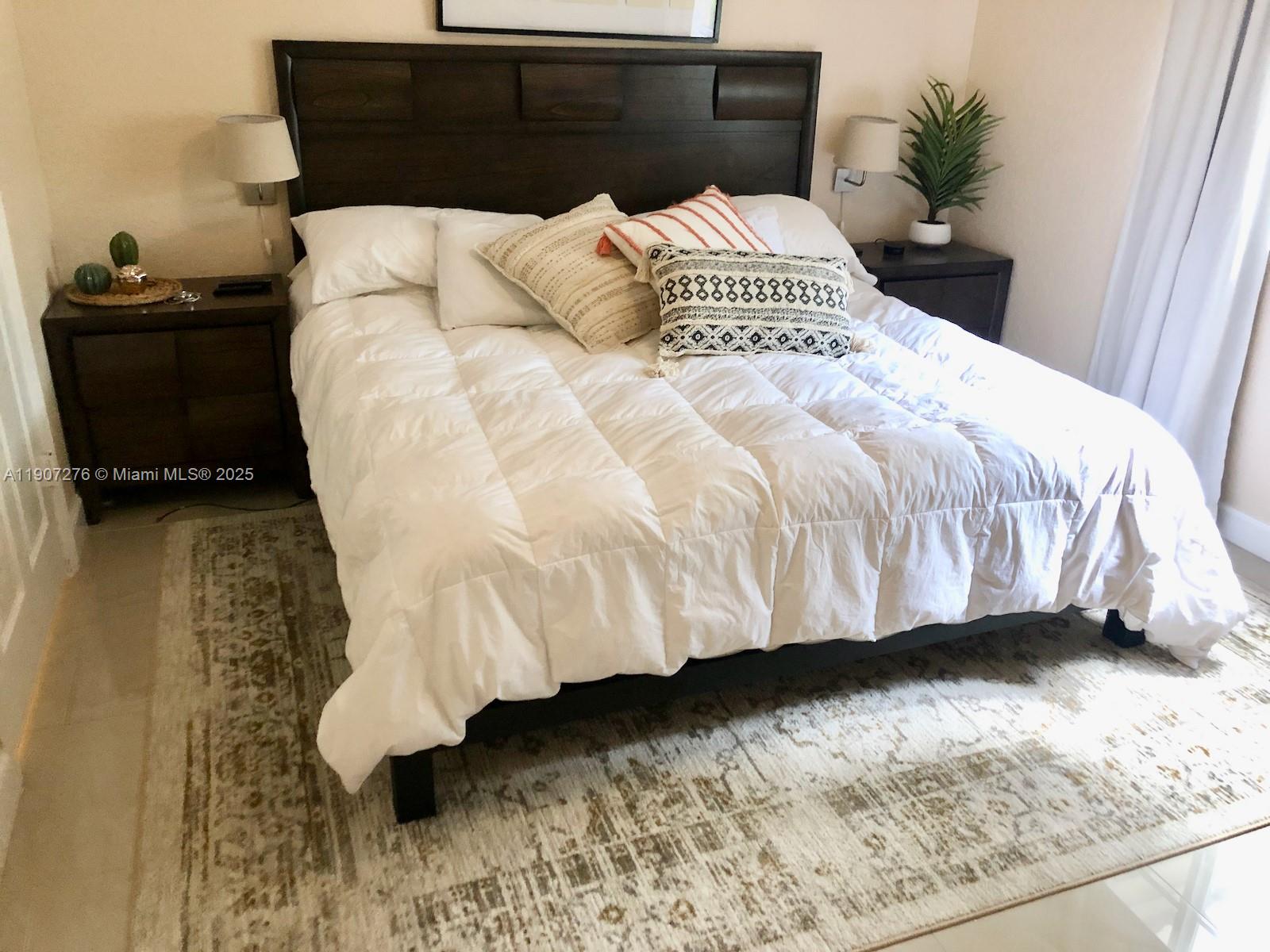 2532 Centergate Drive, Unit 102 Miramar, FL 33025 - Photo 30 of 58 a large bed sitting in a bedroom next to a window