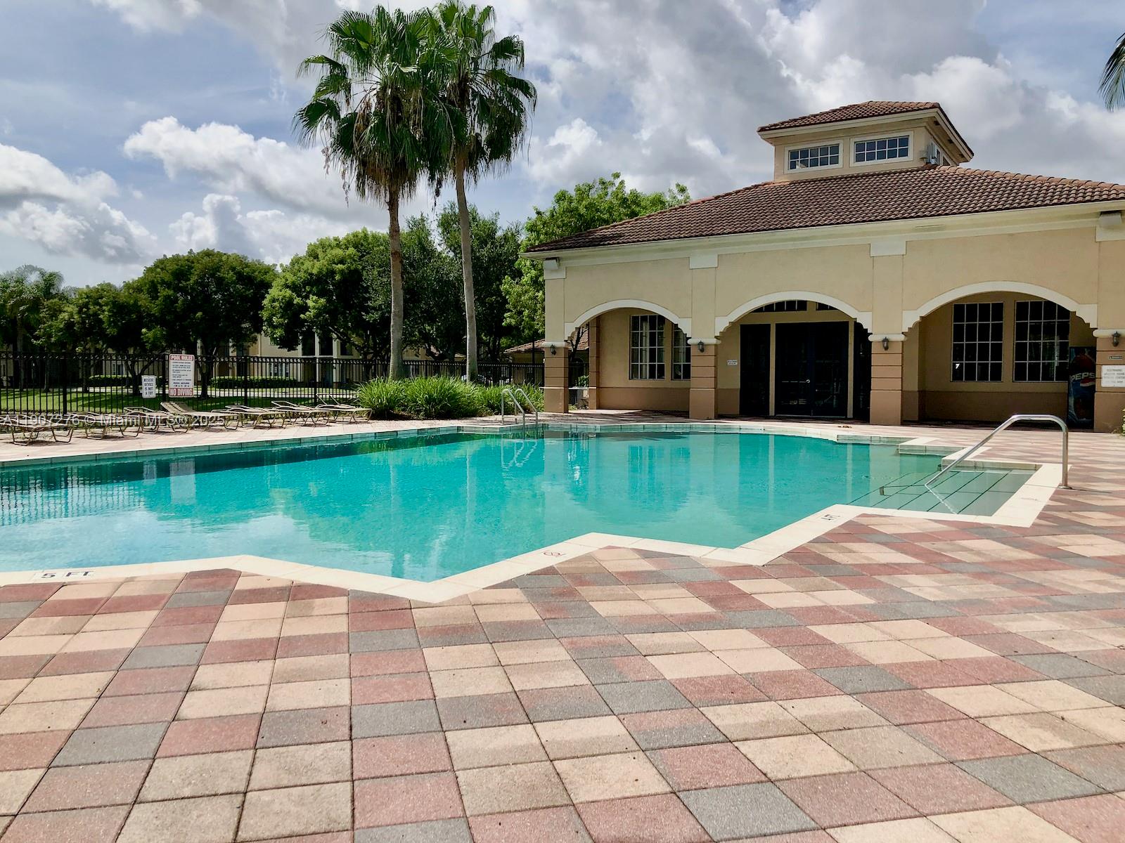 2532 Centergate Drive, Unit 102 Miramar, FL 33025 - Photo 38 of 58 a view of a swimming pool with a garden and plants