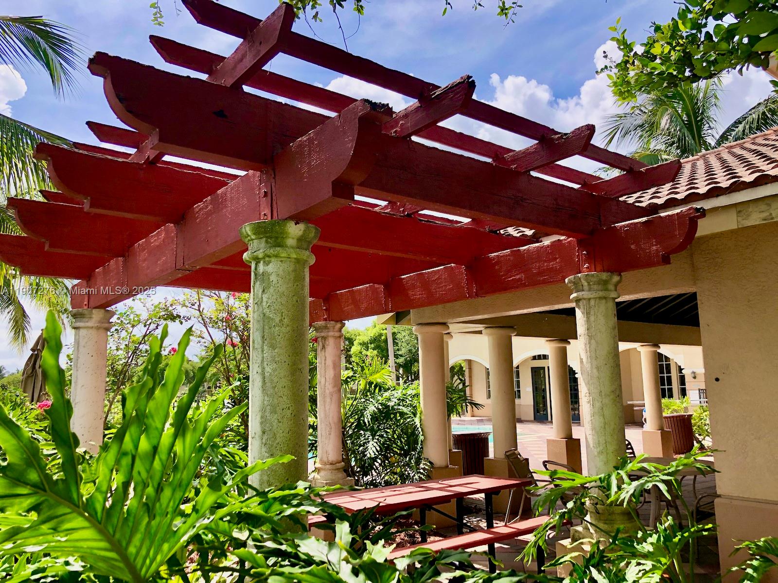 2532 Centergate Drive, Unit 102 Miramar, FL 33025 - Photo 42 of 58 a couple of flower plants in front of building