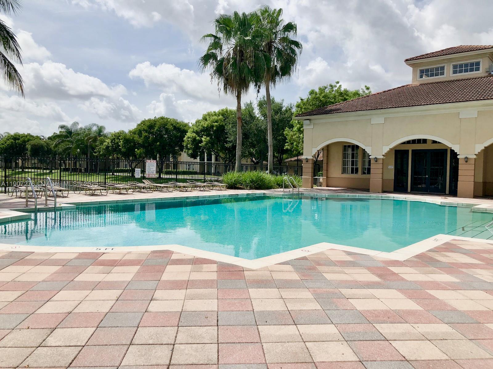 2532 Centergate Drive, Unit 102 Miramar, FL 33025 - Photo 47 of 58 a view of swimming pool with a yard and plants