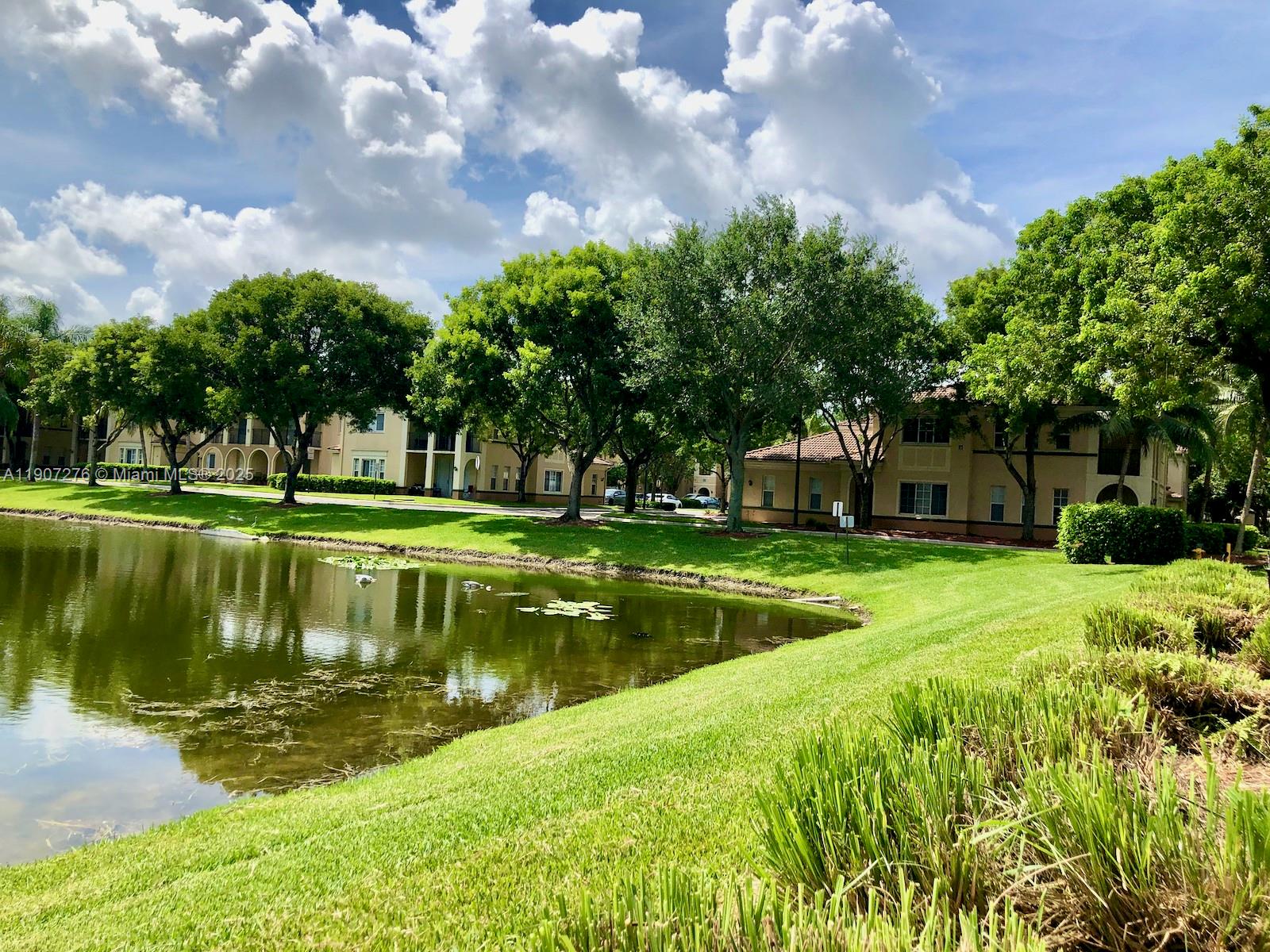 2532 Centergate Drive, Unit 102 Miramar, FL 33025 - Photo 52 of 58 a view of a lake view with a garden