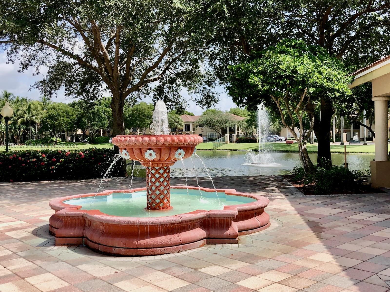 2532 Centergate Drive, Unit 102 Miramar, FL 33025 - Photo 58 of 58 a backyard of a house with fire pit and outdoor seating