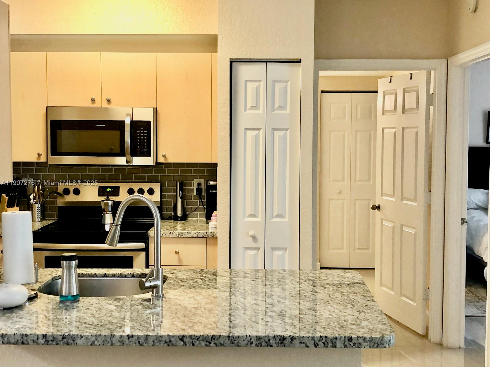 2532 Centergate Drive, Unit 102 Miramar, FL 33025 - Photo 9 of 58 a view of a living room with a flat screen tv