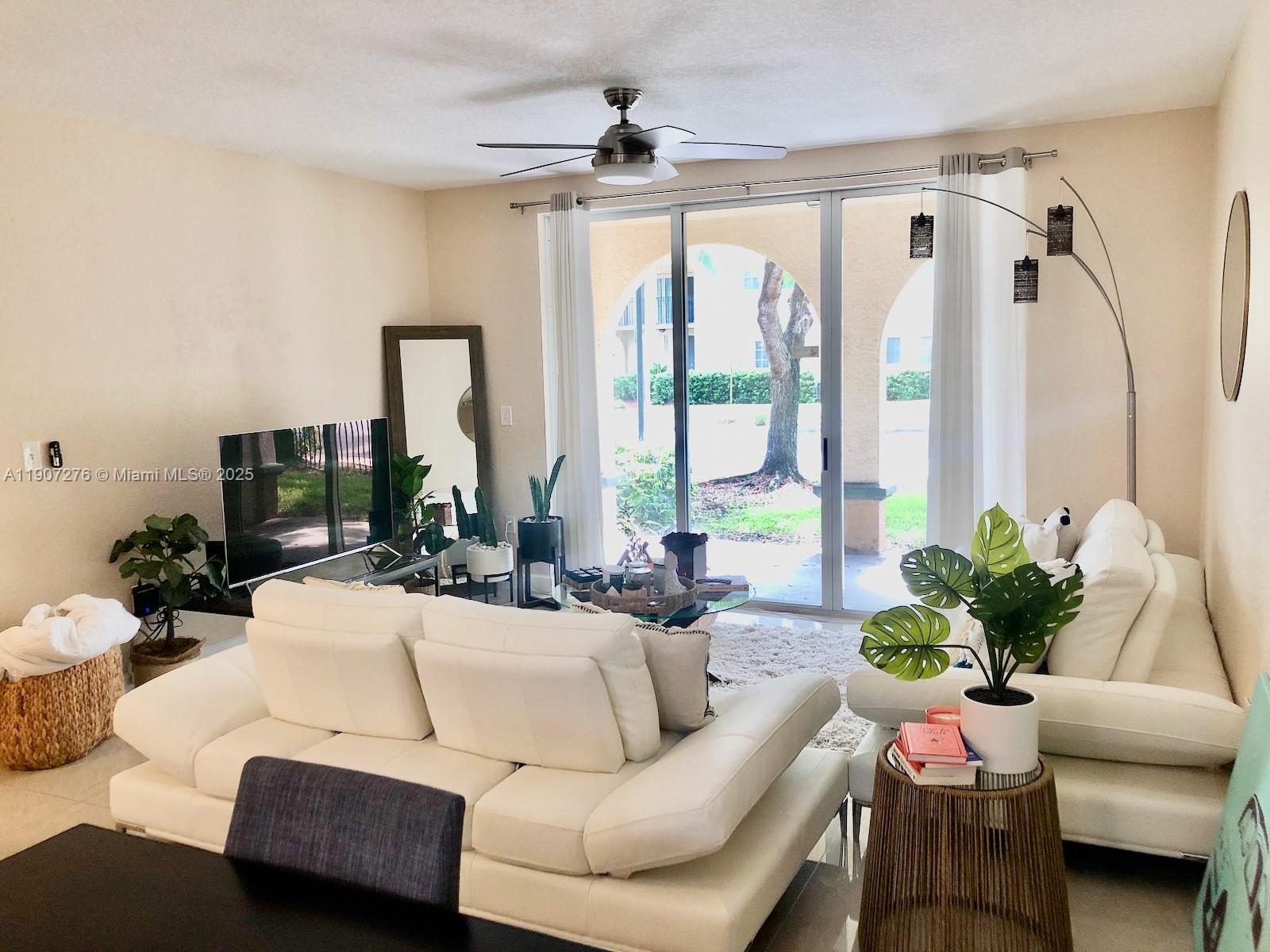 2532 Centergate Drive, Unit 102 Miramar, FL 33025 - Photo 10 of 58 a living room with furniture and a large window