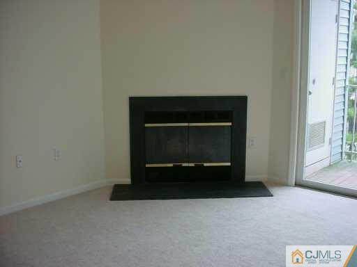 224 Edpas Road New Brunswick, NJ 08901 - Photo 2 of 8 a living room with a fireplace