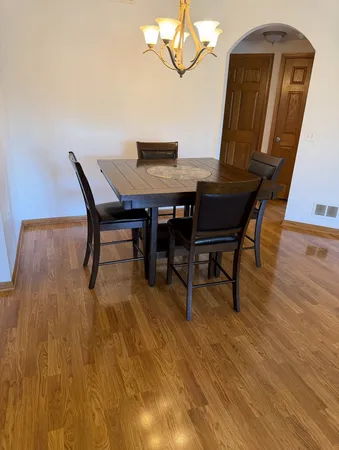 a view of a dining room with furniture and wooden floor