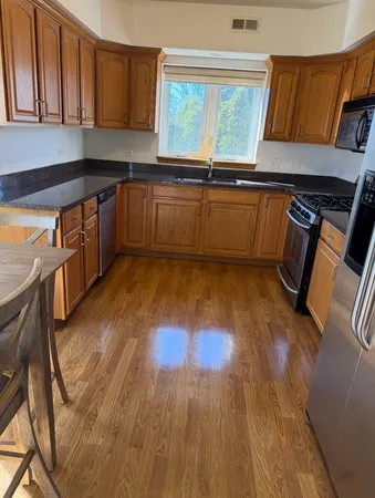 a kitchen with wooden floors and a sink