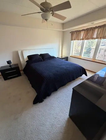 a bedroom with two beds and a window