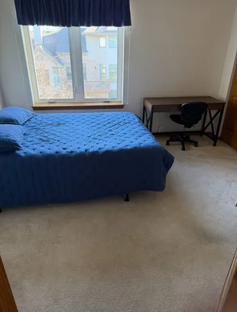 a bed sitting in a room next to a window