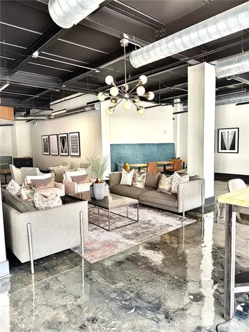 a living room with furniture and a chandelier