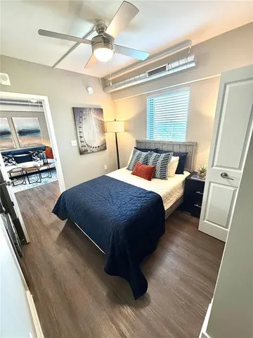 a bedroom with a bed and wooden floor