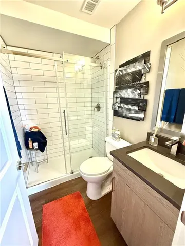a bathroom with a sink a toilet and shower