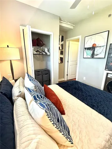 a bedroom with a bed and a painting on the wall